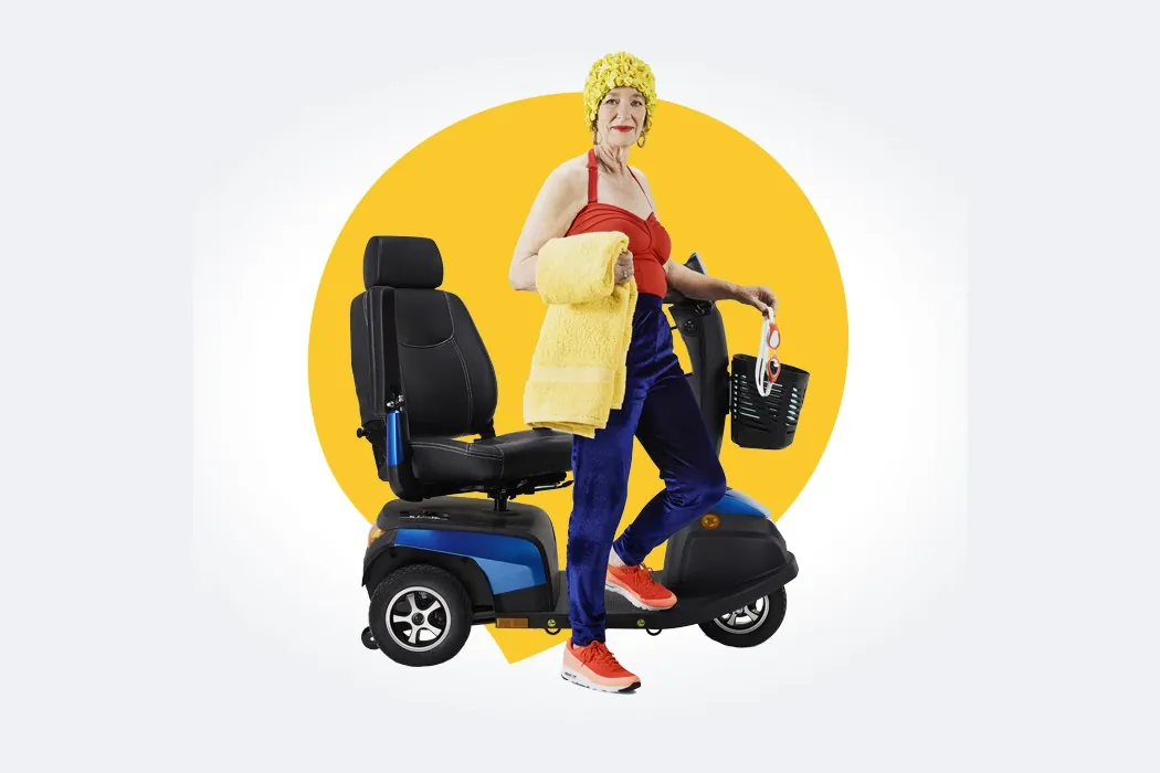 A smiling woman next to a blue mobility scooter with a basket