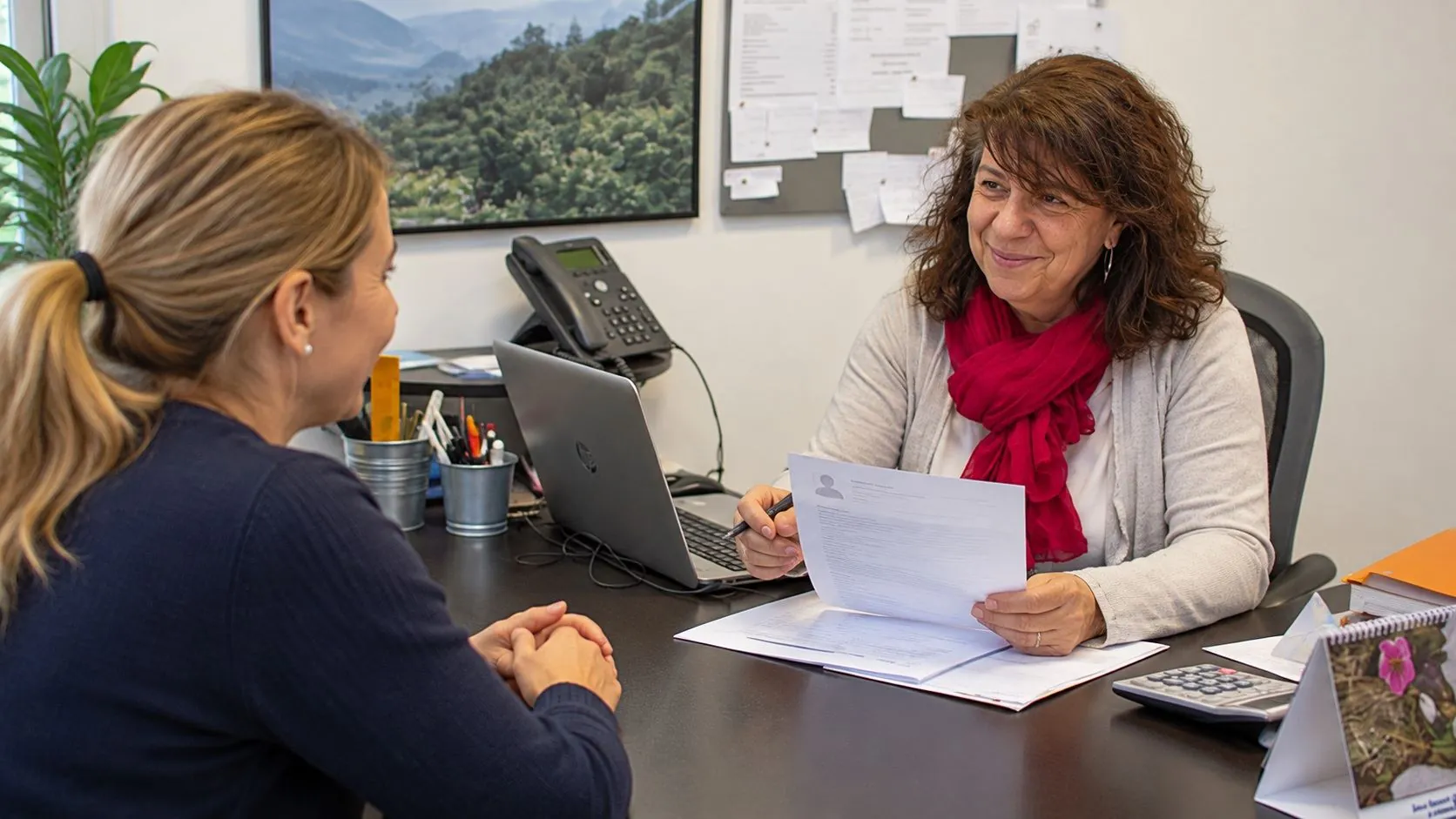 An introductory interview: the coordinator reading a candidate’s CV at her desk