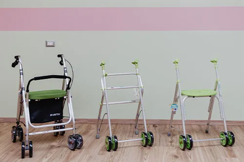 A rollator and two walking frames with seats side by side in the Cocoon shop